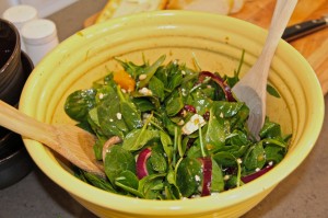 spinach, mandarin orange salad in yellow bowl