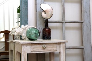 beachy chic side table with sea shells, glass float, and coral