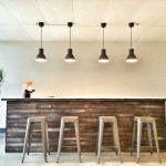 rustic weathered wood bar with metal barstools and 4 pendants